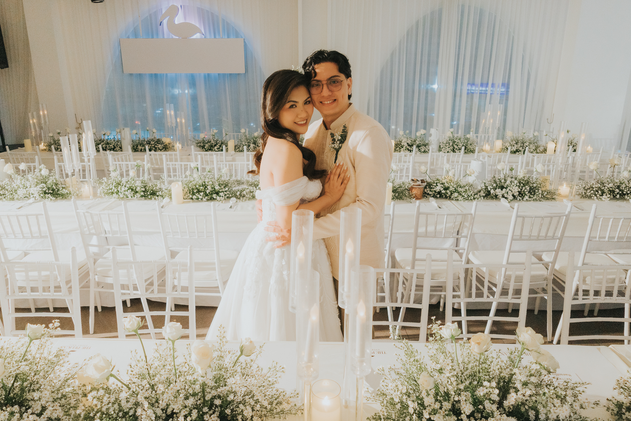 All-white wedding reception styling with baby's breath and gold chairs at Montebello Villa Hotel, a garden venue in Cebu